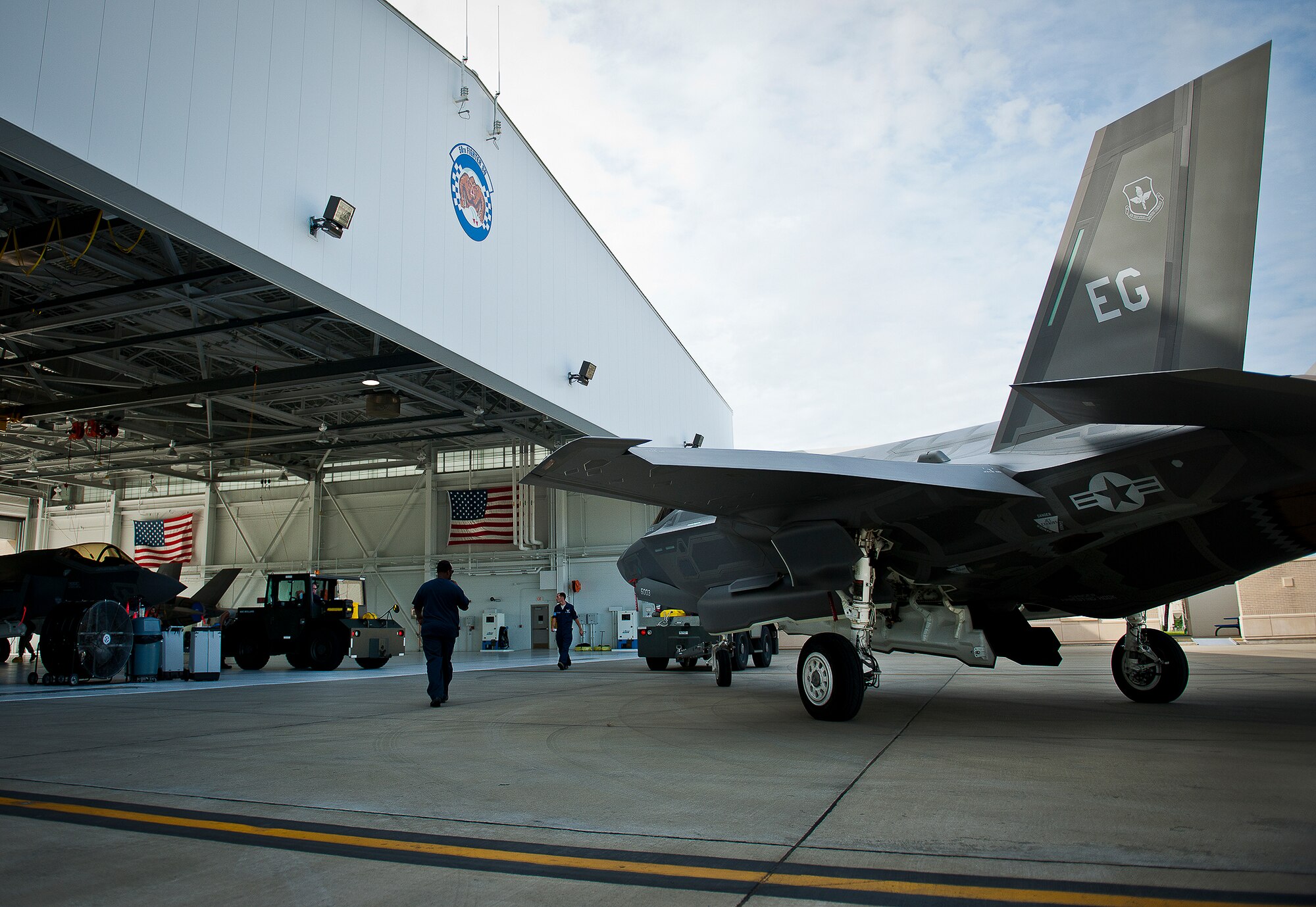 A 33rd Maintenance Squadron Airman backs in an Air Force F-35A Lightning II into the 58th Fighter Squadron hangar at Eglin Air Force Base, Fla., Aug. 27.  The 33rd Fighter Wing’s joint strike fighters were moved into hangars in preparation for the arrival of Hurricane Isaac.  The 58th hangar held nine A models, while the Marine Fighter Attack Squadron 501 hangar stored the 10 B models.  (U.S. Air Force photo/Samuel King Jr.)  