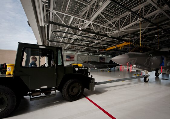 A 33rd Maintenance Squadron Airman backs in an Air Force F-35A Lightning II into the 58th Fighter Squadron hangar at Eglin Air Force Base, Fla., Aug. 27.  The 33rd Fighter Wing’s joint strike fighters were moved into hangars in preparation for the arrival of Hurricane Isaac.  The 58th hangar held nine A models, while the Marine Fighter Attack Squadron 501 hangar stored the 10 B models.  (U.S. Air Force photo/Samuel King Jr.)  