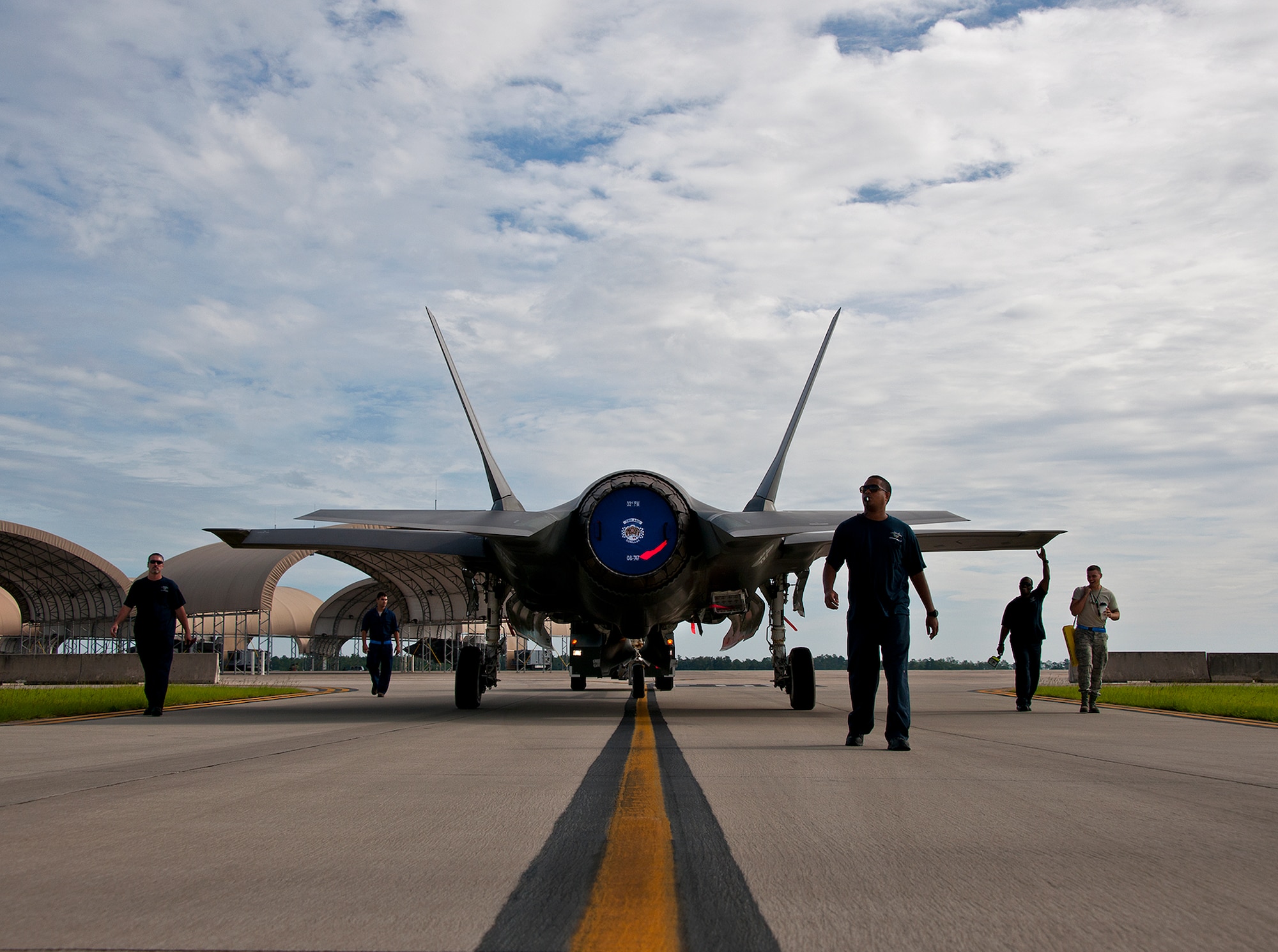 Members of the 33rd Maintenance Squadron move an Air Force F-35A Lightning II off the flightline and into a hangar at Eglin Air Force Base, Fla., Aug. 27.  The 33rd Fighter Wing’s joint strike fighters were moved into hangars in preparation for the arrival of Hurricane Isaac.  The 58th Fighter Squadron hangar held nine A models, while the Marine Fighter Attack Squadron 501 hangar stored the 10 B models.  (U.S. Air Force photo/Samuel King Jr.)  