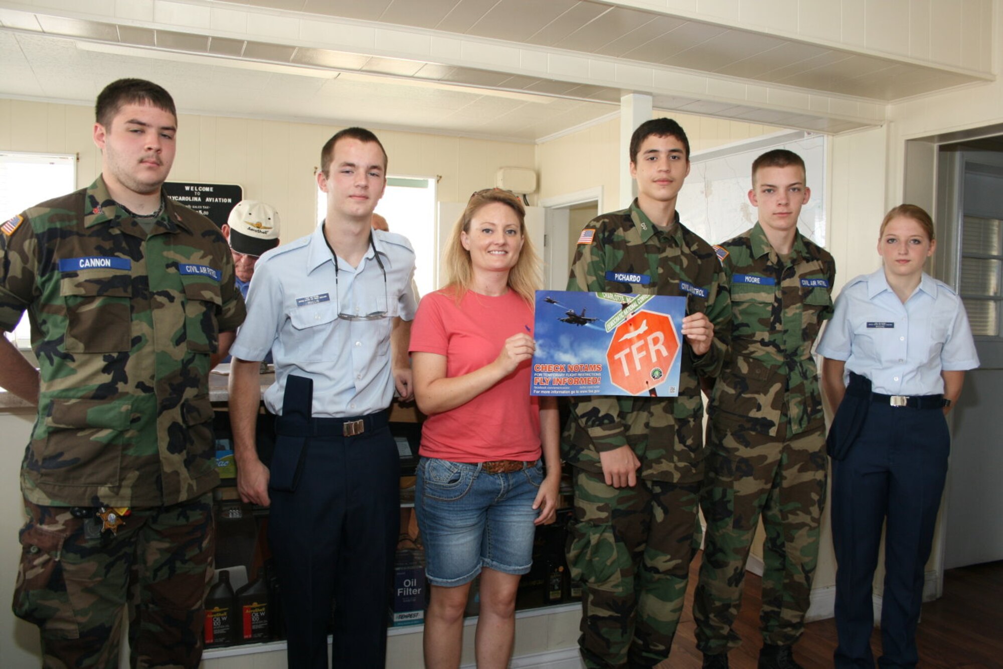 NC Wing Cadets on Hand to Deliver FAA Poster to Gastonia Flight Instructor L-R: Cadets Alan Carter, Billy Mullis, (Jill Cagle), Miguel Pichardo, Stephen Moore, and Alyssa Stokes. Photo by Mr. Hector Pichardo 