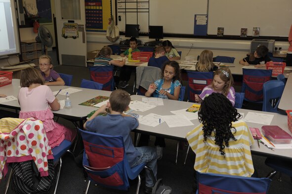 RAF ALCONBURY, United Kingdom – Children work hard on designing their own shirts during their second grade class at the RAF Alconbury elementary school Aug. 27. The day was the first day of classes for students in the 501st Combat Support Wing. (U.S. Air Force photo by Master Sgt. John Barton)
