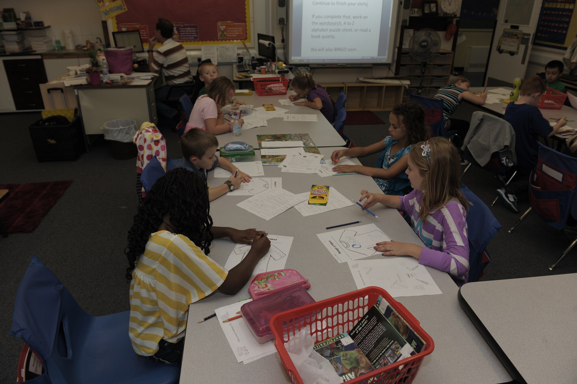 RAF ALCONBURY, United Kingdom – Children work hard on designing their own shirts during their second grade class at the RAF Alconbury elementary school Aug. 27. The day was the first day of classes for students in the 501st Combat Support Wing. (U.S. Air Force photo by Master Sgt. John Barton)