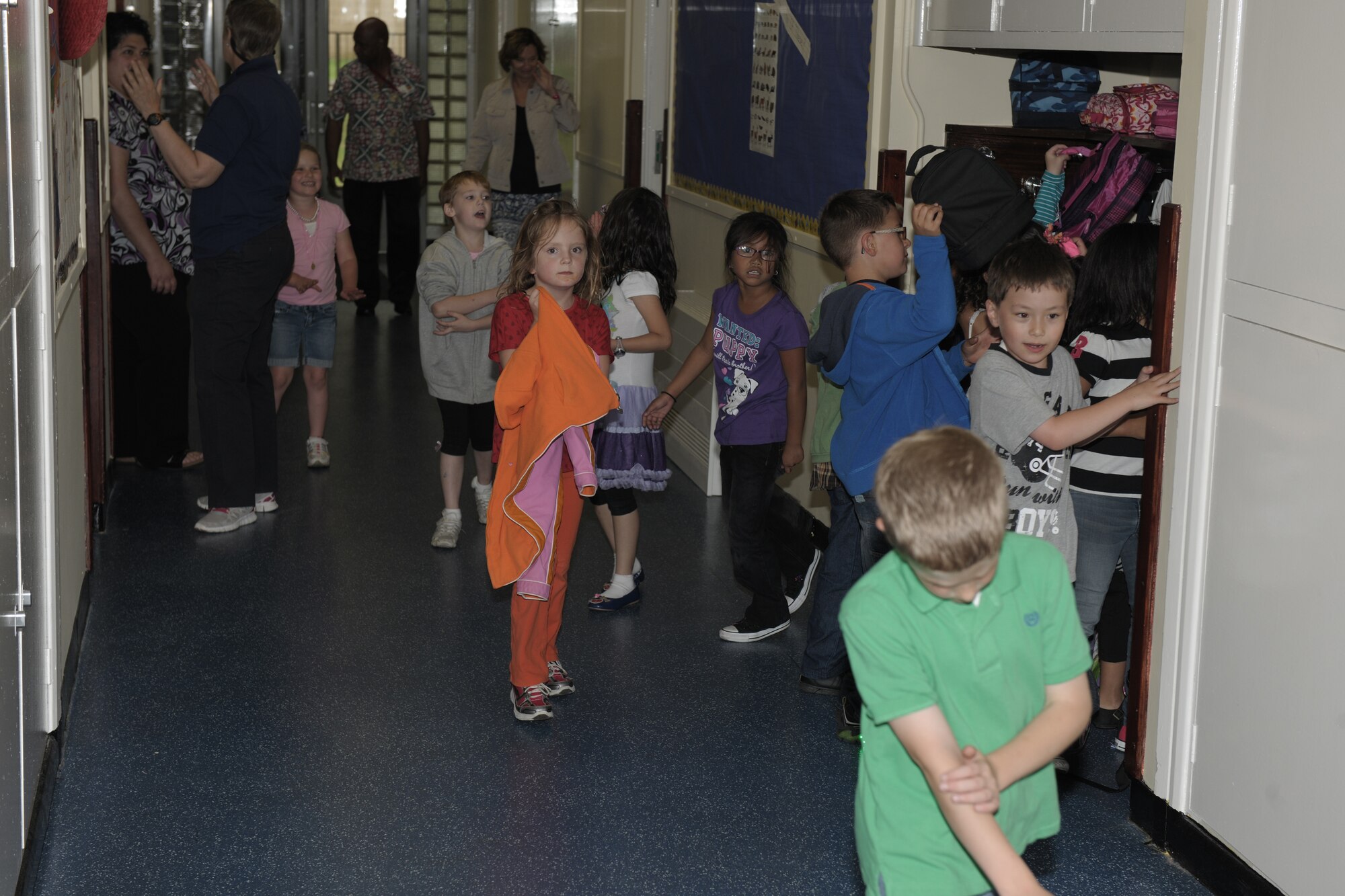 RAF ALCONBURY, United Kingdom – Children put their backpacks and lunch sacks away before heading back into class at the RAF Alconbury elementary school Aug. 27. The day was the first day of classes for students in the 501st Combat Support Wing. (U.S. Air Force photo by Master Sgt. John Barton)
