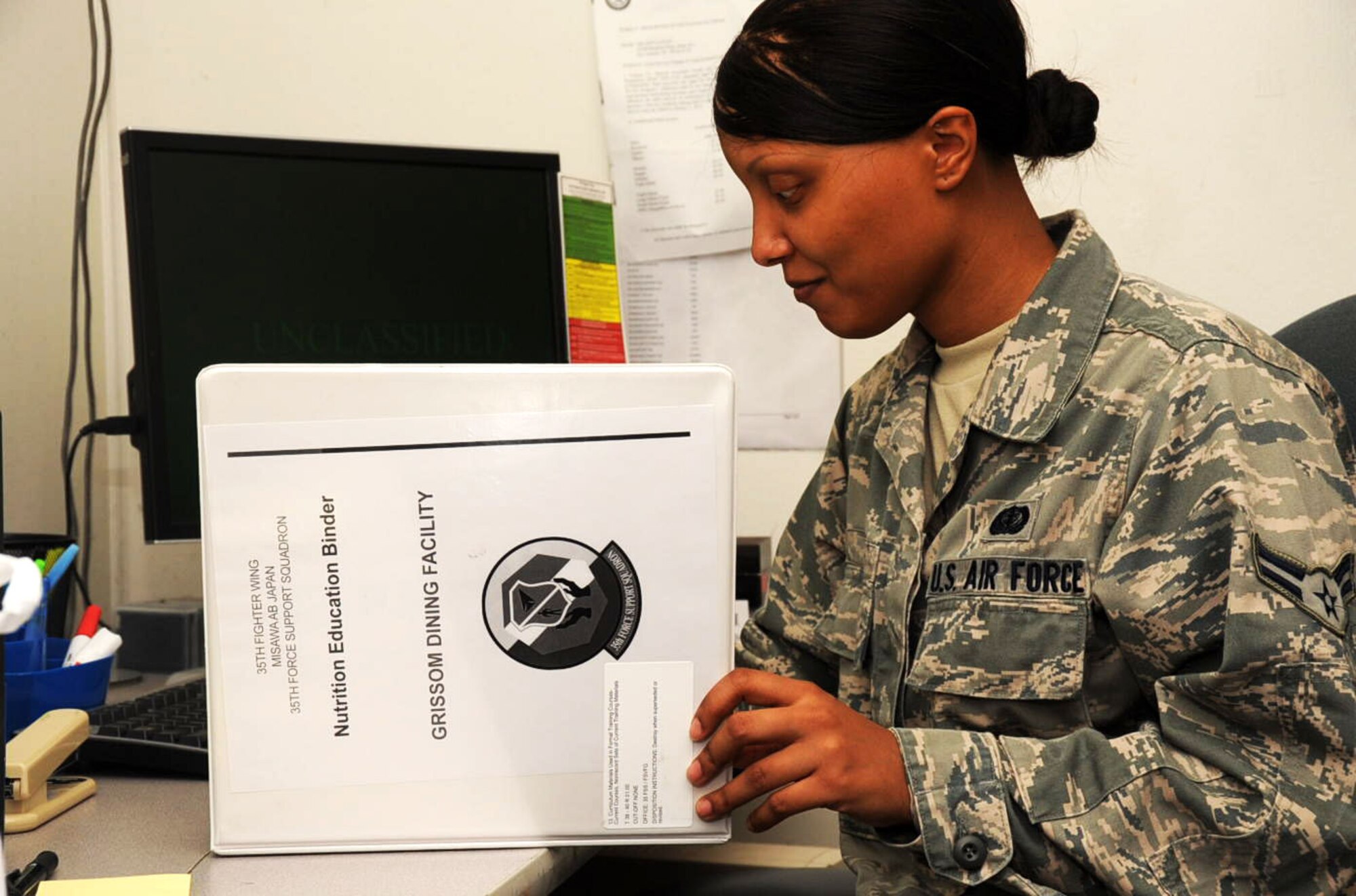 U.S. Air Force Airman 1st Class Secoria Hill, 35th Force Support Squadron food apprentice, updates the 35 FSS nutrition education binder and reviews Air Force Instruction 35-87, the check-out checklist, in the Grissom Dining Facility at Misawa Air Base, Japan, Aug. 28, 2012. Updating the binder is a quarterly inspection requirement for the 35 FSS dining facility team members. All over base, Airmen are doing their part to prepare for the consolidated unit inspection coming next month. (U.S. Air Force photo by Airman 1st Class Kenna Jackson/Released)