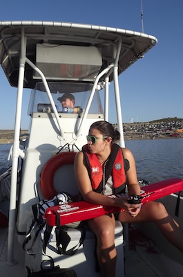 Cochiti Park Ranger Chris Schooley (driving boat) and Kelly Burggraaf, a lifeguard from UNM, stay vigilant during the swimming leg of the Cochiti Triathlon.