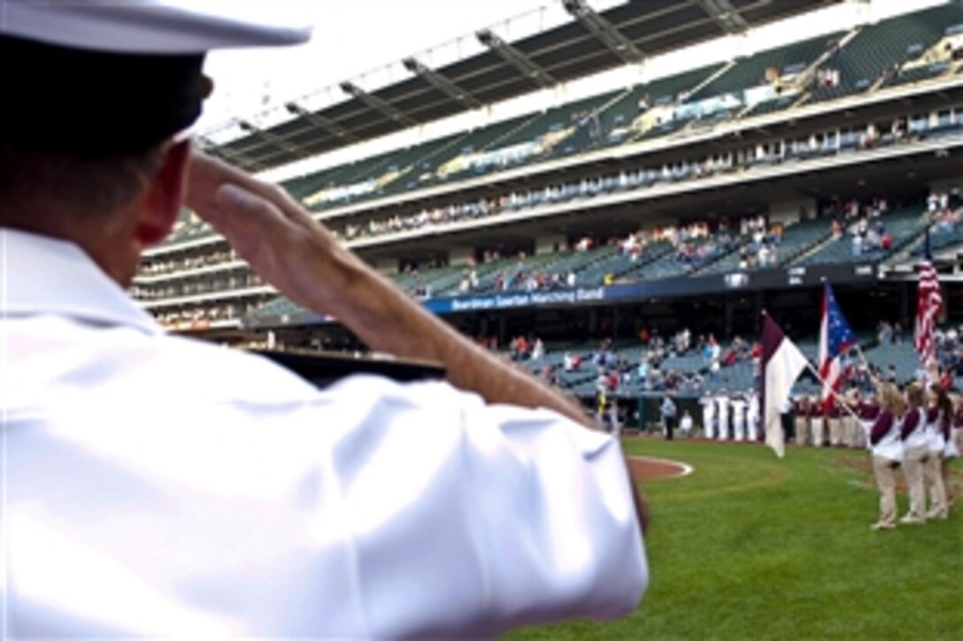 Navy Adm. James A. Winnefeld Jr., vice chairman of the Joint Chiefs of Staff, renders honors during the playing of the national anthem on Progressive Field in Cleveland, Aug. 27, 2012. 