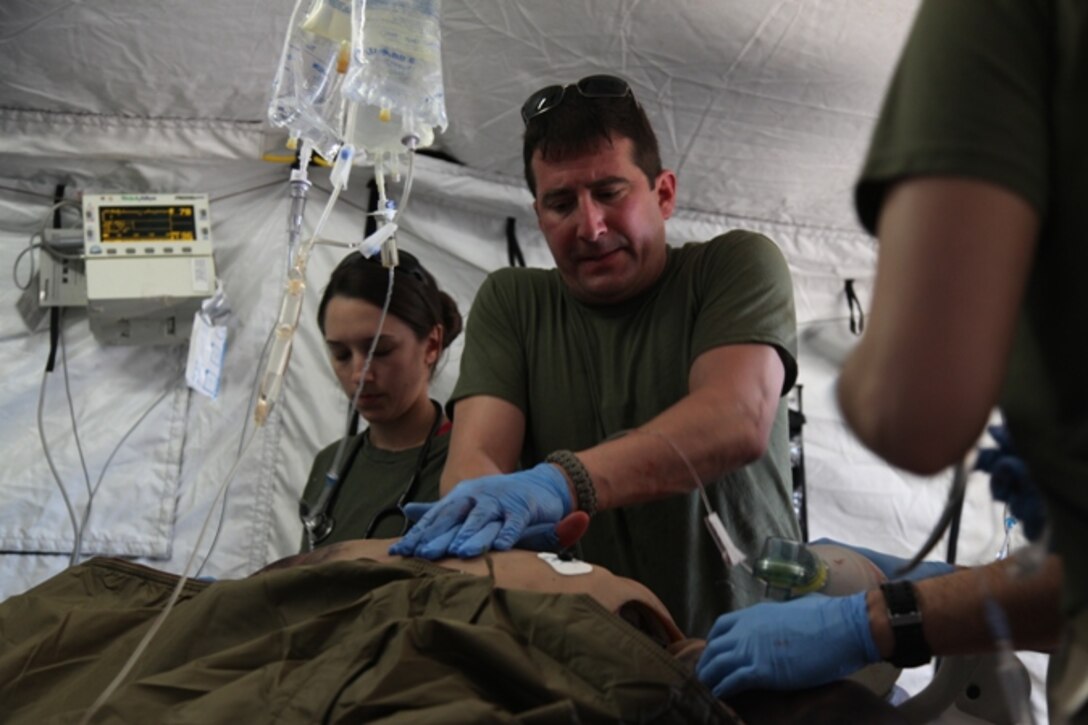 A doctor with 1st Medical Battalion, 1st Marine Logistics Group, performs continuous chest compressions in order to save a simulated casualty during a field training exercise aboard Camp Pendleton, Calif., Jan. 26. As part of the training, several waves of simulated casualties continuously arrived on site and required immediate treatments to simulate the stress of combat.