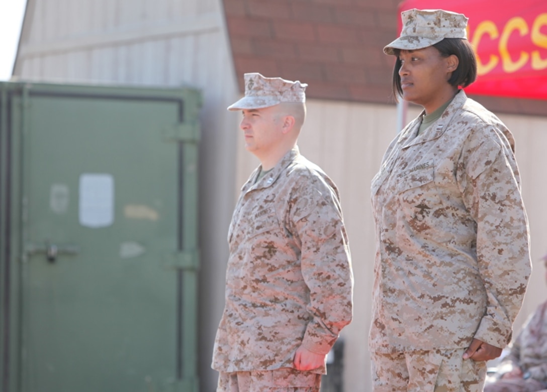 Capt. Jason M. Kikta, (left), and Capt. Natasha M. Everly, stand at the position of attention during Communications Company’s change of command ceremony at Camp Pendleton, Calif., March 30. Kikta relinquished command of Communications Company, Combat Logistics Regiment 17, 1st Marine Logistics Group, to Everly.