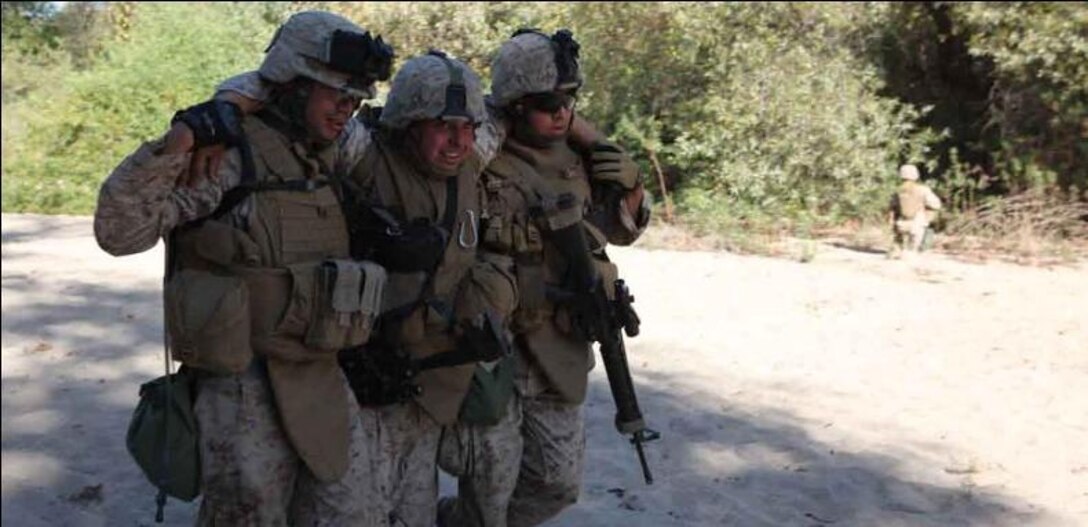 Marines with Combat Logistics Battalion 15, 1st Marine Logistics Group, evacuate a 'casualty' after a mock firefight at the Enhanced Combat Training course aboard Camp Pendleton, Calif., Oct. 27.