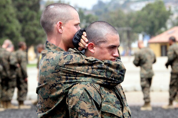A recruit executes a rear choke as he and the rest of Company E, 2nd Recruit Training Battalion test out for their tan belt aboard Marine Corps Recruit Depot San Diego Aug. 15. The Marine Corps Martial Arts Program teaches Marines how to defend themselves with hand-to-hand combat and instills discipline and a warrior mindset.