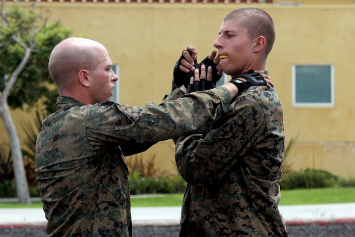 A recruit executes a basic wrist-lock takedown as part of his tan belt test in Marine Corps Martial Arts aboard Marine Corps Recruit Depot San Diego Aug. 15. Recruits are taught how to defend themselves with unarmed restraints and joint manipulations if someone were to try to grab them.