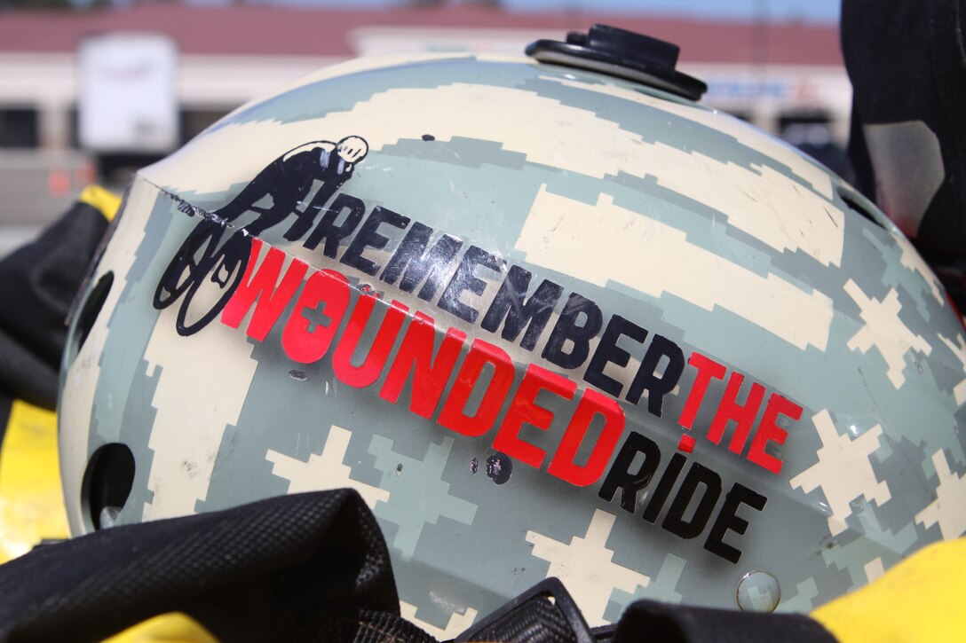 Scot King's helmet promoting his organization, The Wounded Ride, Inc. sits atop his bicycle. King established the program after encountering a homeless Marine in his hometown of Portland, Ore. King is riding across the country on a bicycle and writing a series of books detailing the lives of veterans to raise money and awareness for service members and their families in need of assistance.
