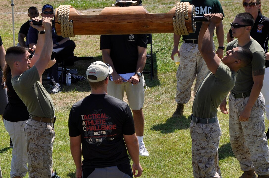 Marines from 1st Light Armored Reconnaissance Battalion’s Bravo Company, Weapons Platoon, also known as the "Awesome" team, participate in a log-press during the Tactical Athlete Challenge at Camp Pendleton's Paige Fieldhouse, Aug. 28.