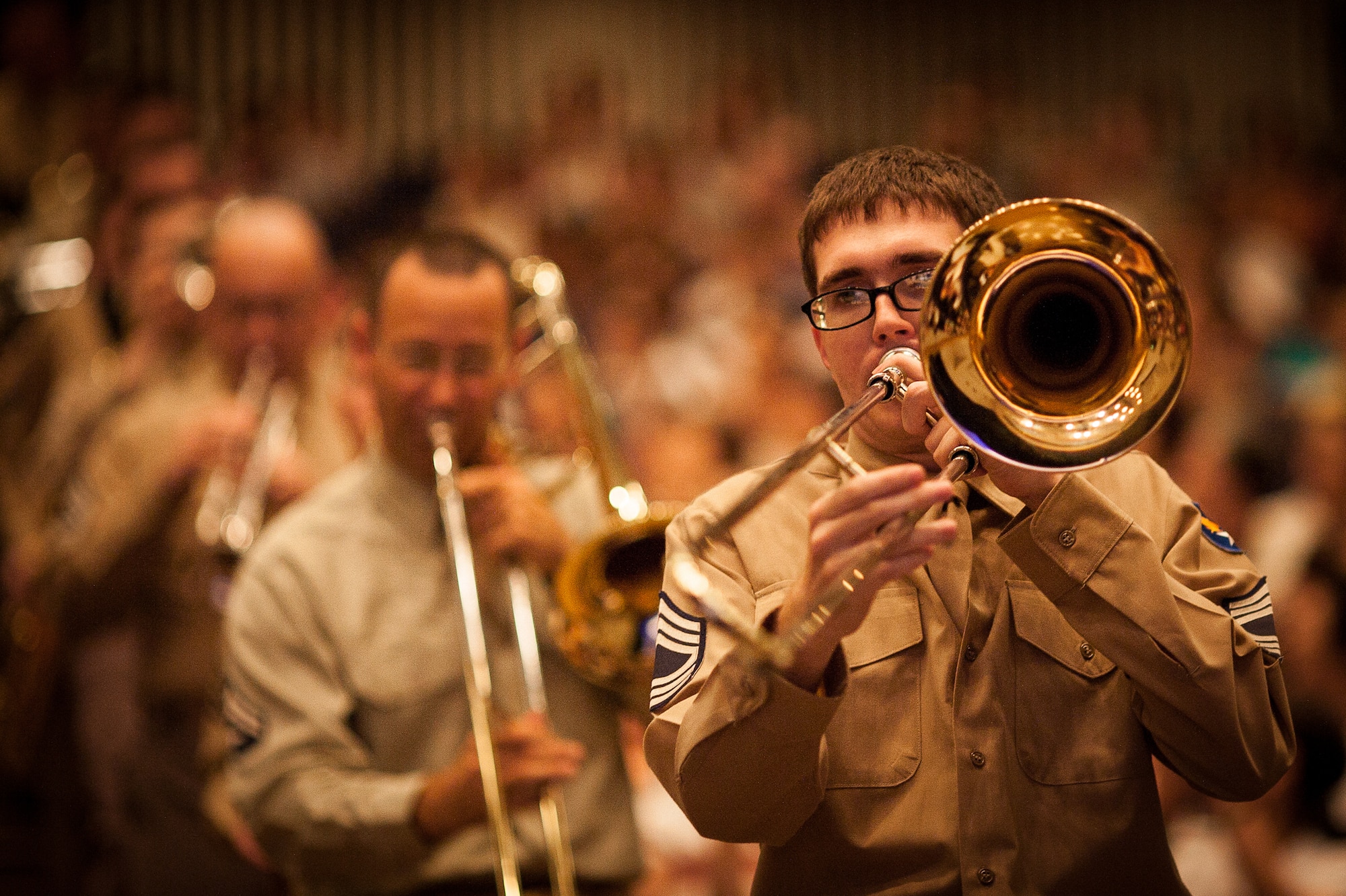 FUSSA CITY, Japan -- Senior Airman Mark Shoun, Band of the Pacific-Asia trombonist, leads Pacific Showcase through the aisles at the Fussa-Yokota Friendship Concert, Fussa City, Japan on Aug. 28, 2012. Showcase played "When the Saints Go Marching In," in the midst of the audience for their encore. (U.S. Air Force photo by Staff Sgt. Josh Voyles)