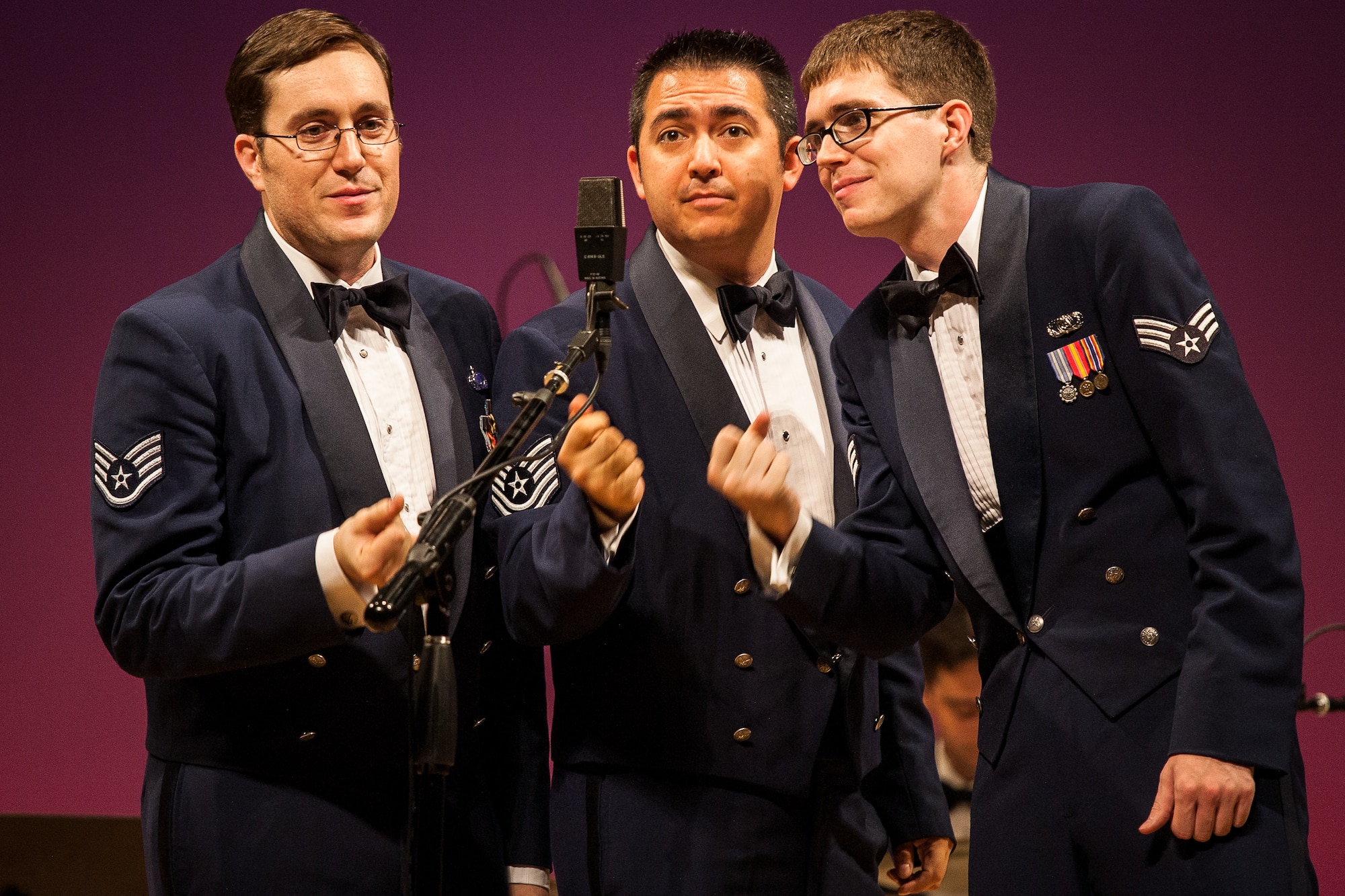 FUSSA CITY, Japan -- Staff Sgt. Tom Salyers, left, Band of the Pacific-Asia trumpet player, Tech. Sgt. Justin Allen, center, Band of the Pacific-Asia vocalist, and Senior Airman Mark Shoun, right, Band of the Pacific-Asia trombonist, sing and snap thier fingers to "Hit That Jive, Jack" at the Fussa-Yokota Friendship Concert, Fussa City, Japan on Aug. 28, 2012. Pacific Showcase's musicians added to the concert by playing many musical roles throughout the night. (U.S. Air Force photo by Staff Sgt. Josh Voyles)