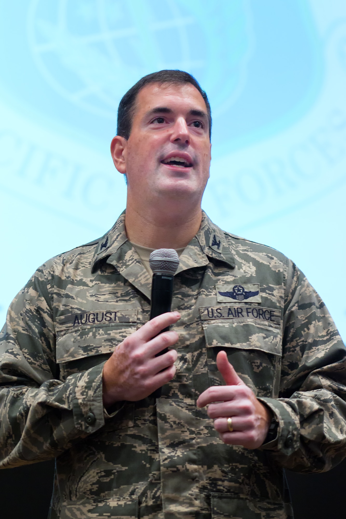YOKOTA AIR BASE, Japan -- Col. Mark August, 374th Airlift Wing commander, talks about his vision to the audience during a commander's call, Aug. 30, 2012 at Yokota Air Base, Japan. August outlined his goals and expectations along with congratulating the wing on recent successes. (U.S. Air Force photo/Osakabe Yasuo)