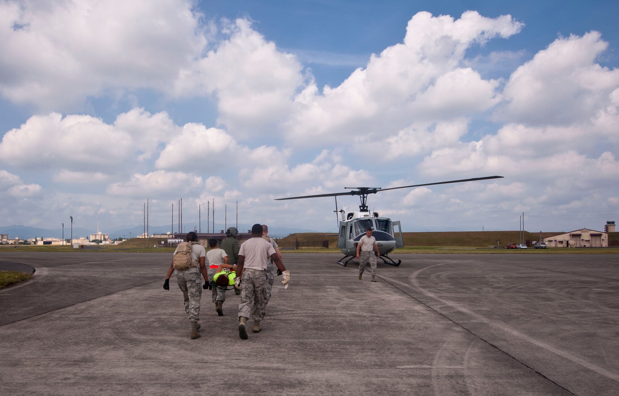 YOKOTA AIR BASE, Japan -- 374th Medical Group Airmen transport a simulated victim to a UH-1N Iroquois during a joint Army and Air Force medical exercise at Yokota Air Base, Japan, Aug. 28, 2012. In a span of 7 hours, 374 MDG Airmen transferred simulated patients to and from the Mobile Aeromedical Staging Facility. (U.S. Air Force photo by Airman 1st Class Krystal M. Garrett)