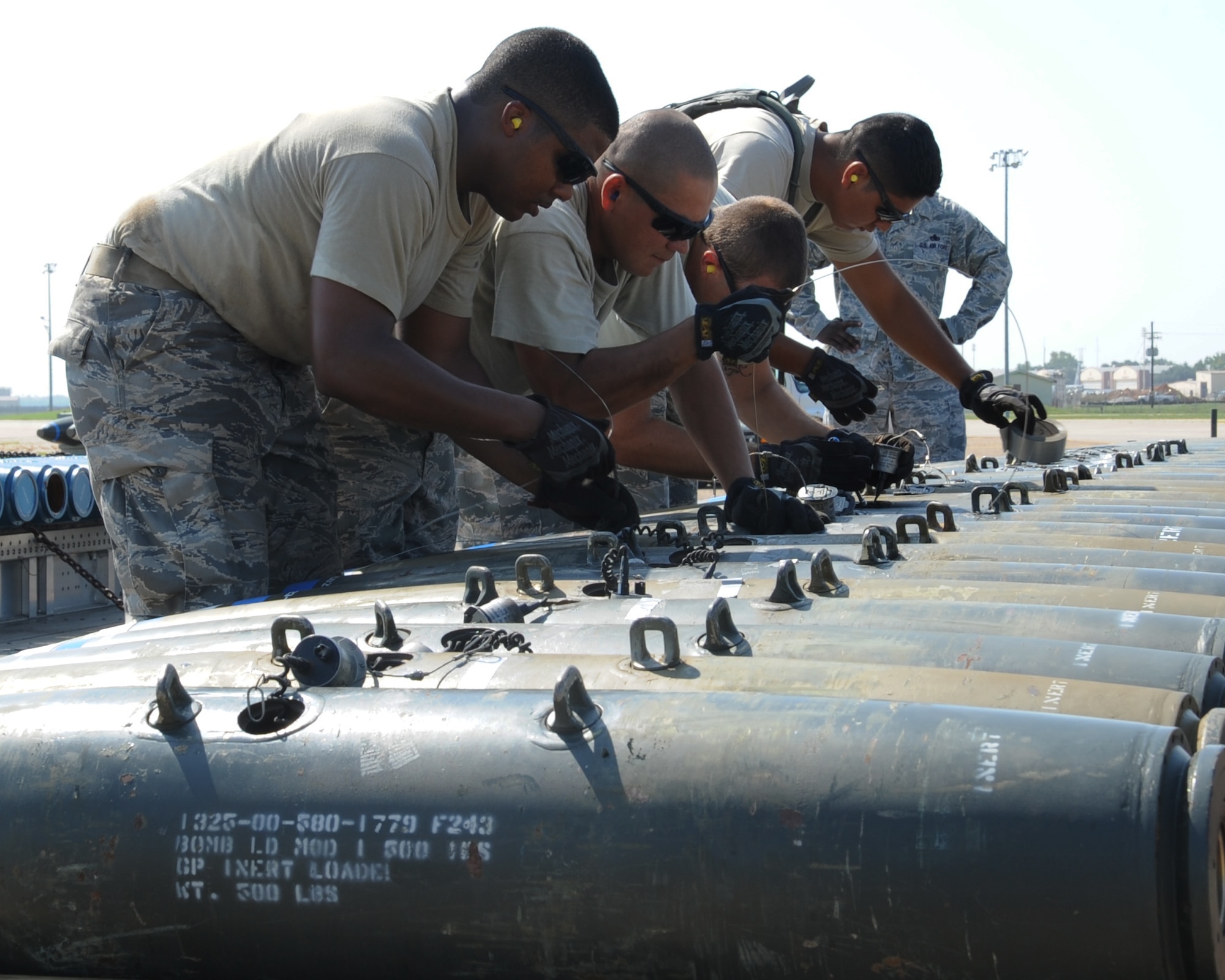 Airmen from the 2nd Munitions Squadron munitions maintenance team assemble Mark-82 bombs during the 2012 annual Global Strike Challenge on Barksdale Air Force Base, La., Aug. 28. The 11-person team was evaluated in various areas of the build-up to include torque requirements, trailer loading procedures, technical order knowledge and safety procedures. (U.S. Air Force photo/Senior Airman Sean Martin)(RELEASED)
