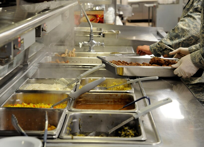 Food service Airmen at the Red River Dining Facility bring fresh food to the serving line on Barksdale Air Force Base, La., Aug 28. Food service Airmen prepare and cook all food from raw ingredients to serve to Barksdale Airmen. (U.S. Air Force photo/Airman 1st Class Andrew Moua)(RELEASED)