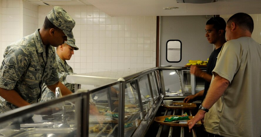 Airman 1st Class Yontaireus McCray, 2nd Force Support Squadron, and Senior Airman Jose Ortiz, 2 FSS, serve food on Barksdale Air Force Base, La., Aug 28. Food service Airmen at the Red River Dining Facility are responsible for the preparation and serving of meals and keeping the facility clean. (U.S. Air Force photo/Airman 1st Class Andrew Moua)(RELEASED)