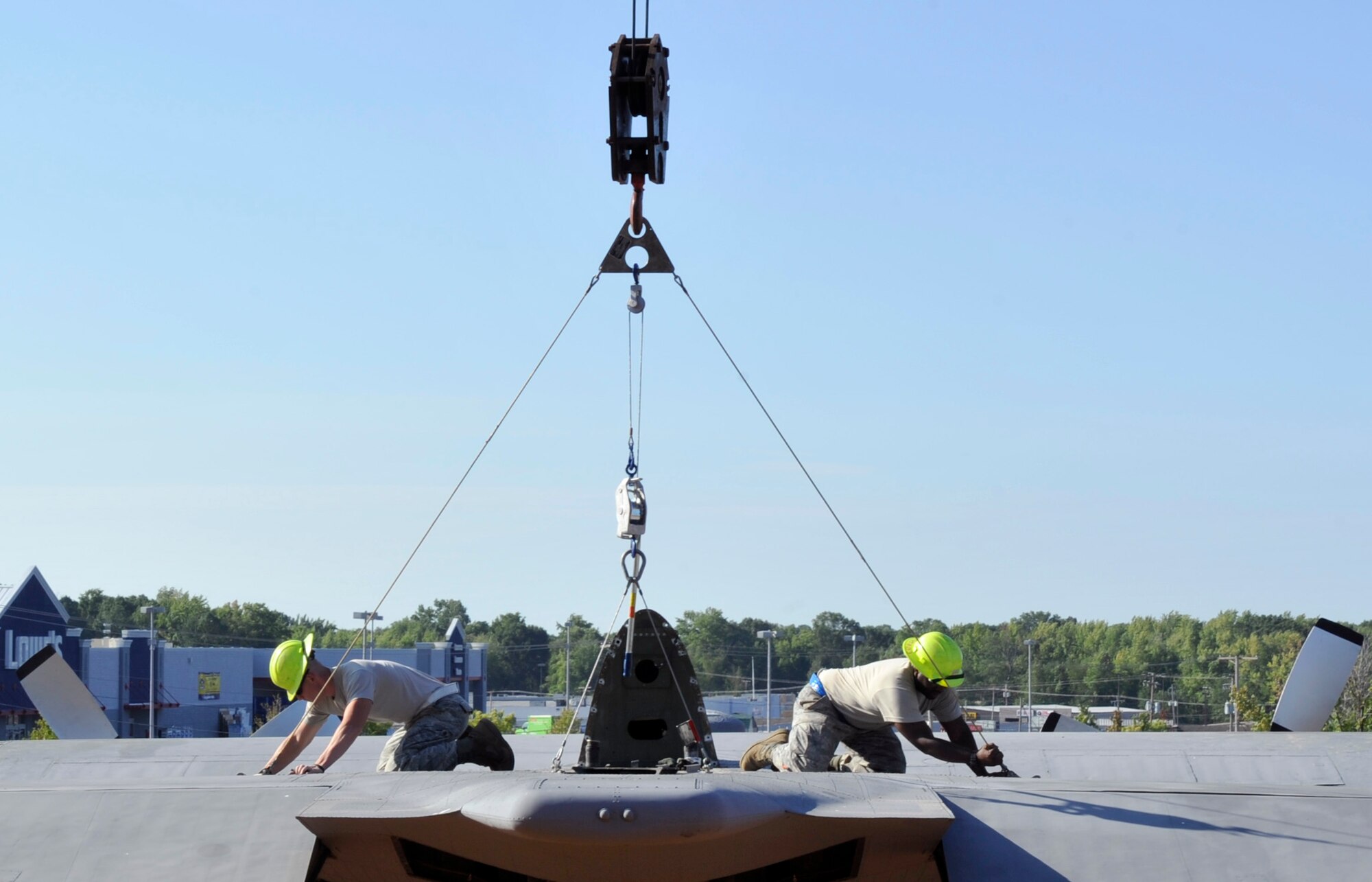 Members of the 19th Equipment Maintenance Squadron attach a horizontal tail piece to a C-130E Aug. 29, 2012, in Jacksonville, Ark. This C-130 has been in service to the Air Force for almost 50 years and is now being retired in front of the Little Rock Air Force Base - City of Jacksonville Joint Education Center. (U.S. Air Force photo by Staff Sgt. Caleb Pierce)
