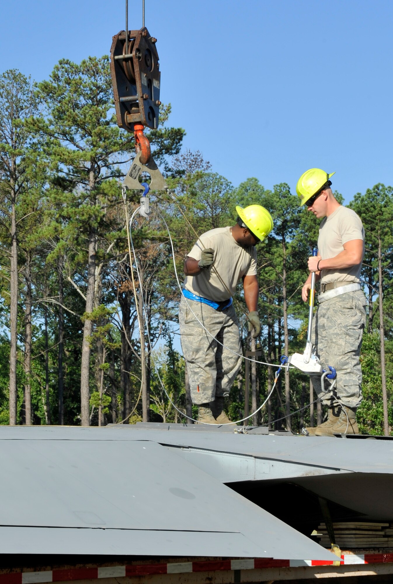 Members of the 19th Equipment Maintenance Squadron hook a crane boom to a horizontal tail piece for a C-130E Aug. 29, 2012, in Jacksonville, Ark. This C-130 is being reassembled in front of the Little Rock Air Force Base - City of Jacksonville Joint Education Center as a static display. (U.S. Air Force photo by Staff Sgt. Caleb Pierce) 