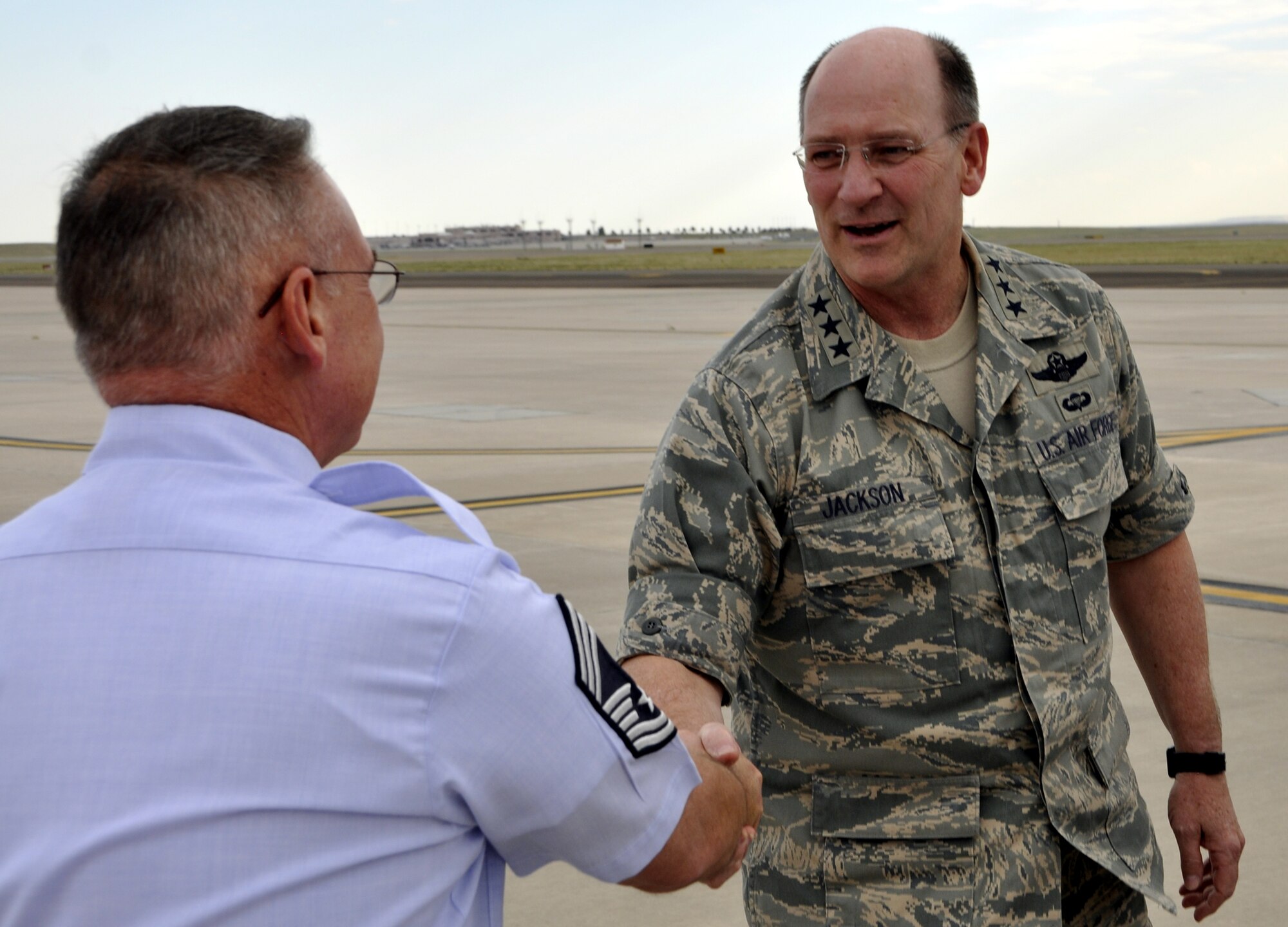 Chief Master Sgt. Brad Bokkean, left, Superintendent and Chief Enlisted Manager of the 52nd Airlift Squadron greets Lt. Gen. James F. Jackson, chief of Air Force Reserve, and commander, Air Force Reserve Command, on the Peterson Air Force Base flightline Aug. 27. The 52nd AS is the Active Duty associate squadron of the 302nd Airlift Wing.  Jackson was in Colorado Springs to meet with members of the Air Force Reserve command’s 302nd AW and the 310th Space Wing, Schriever AFB, Colo. (U.S. Air Force photo/Tech. Sgt. Daniel Butterfield)