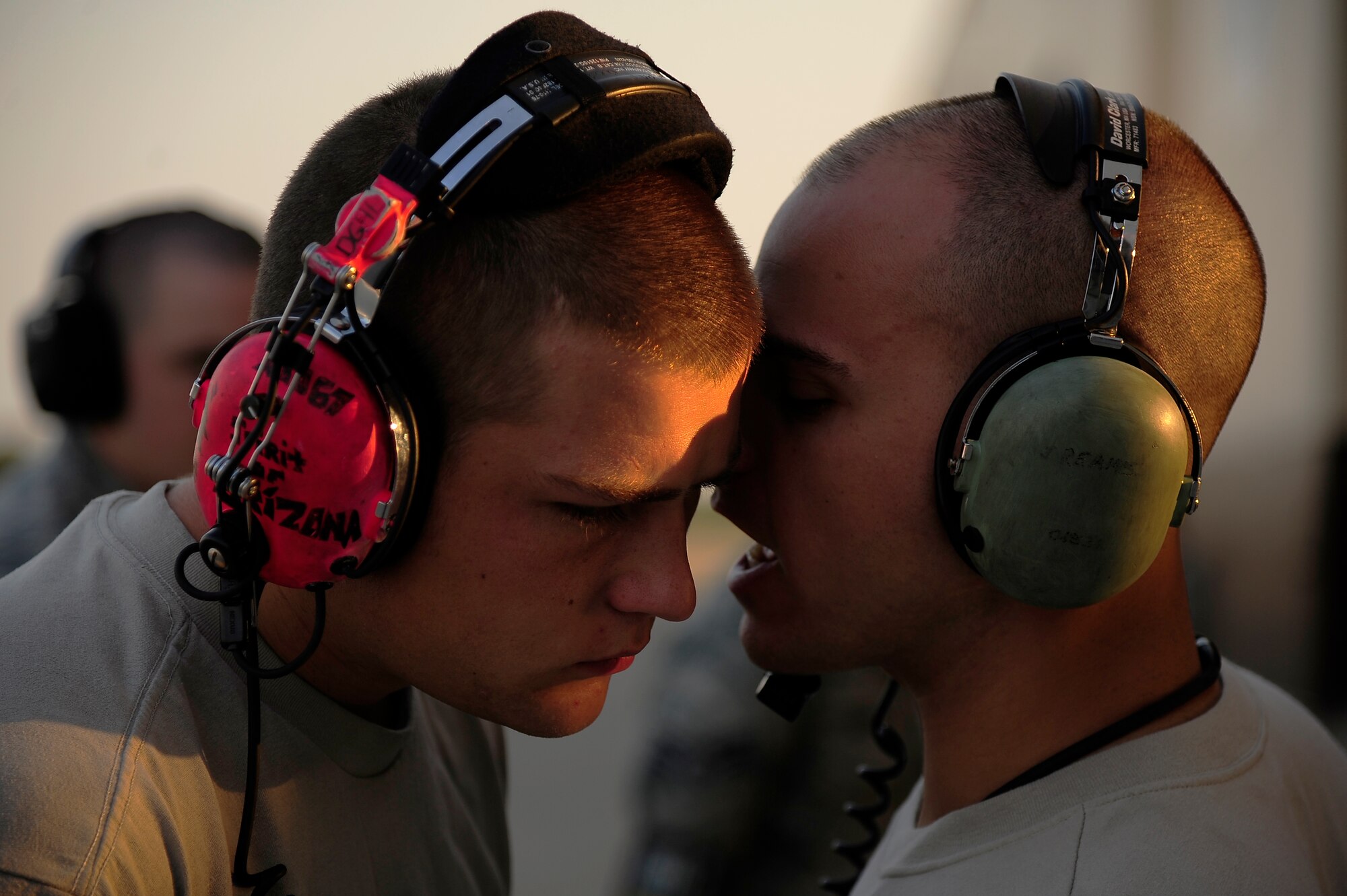 Senior Airman Tyler Gainey and Staff Sgt. Joseph Reames, both 509th Aircraft Maintenance Squadron B-2 Spirit crew chiefs, converse over the roar of a B-2 during a Nuclear Operational Readiness Exercise at Whiteman Air Force Base, Mo., Aug. 29. The exercise allowed the entire wing - active duty, Guard, Reserve, retired and civilians alike - to show their vigilance and teamwork as part of Team Whiteman. (U.S. Air Force photo/ Senior Airman Cody H. Ramirez)