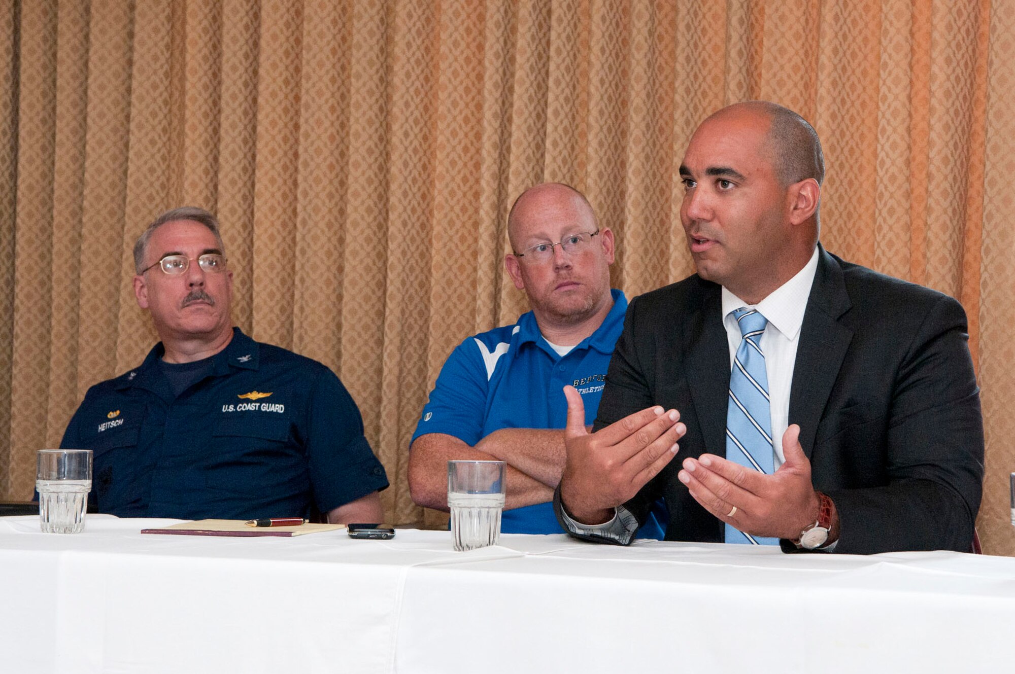 HANSCOM AIR FORCE BASE, Mass. - Henry Turner (right), Bedford High School principal, speaks with base parents whose students will be attending the high school this fall as U.S. Coast Guard Capt. Tim Heitsch and Keith Mangan, Bedford High School athletic director, look on at a principal roundtable at the Minuteman Commons Aug. 23. The roundtable, the first of many scheduled throughout the school year, was a chance for the principal to meet with parents to discuss any and all topics related to the school. (U.S. Air Force photo by Mark Wyatt)