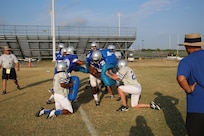 Members of the Randolph High School Ro-Hawks football team run gauntlet drills during early morning practice Aug. 13.
US photo by Rich McFadden