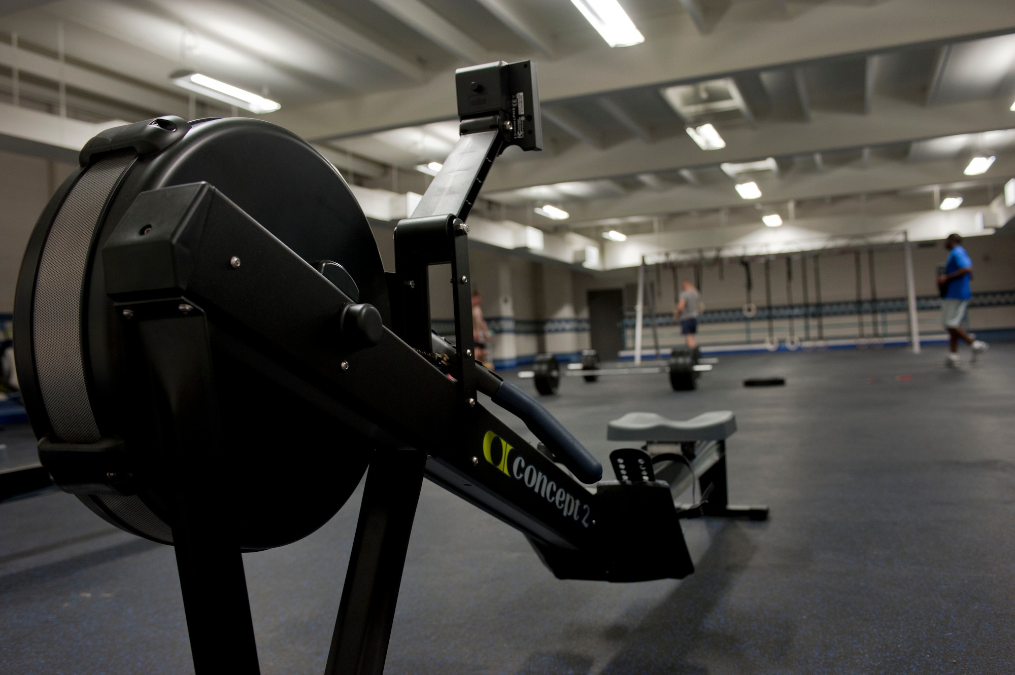 Three Airmen work out in the newly-converted “Warrior Zone” located inside the Air Combat Command Fitness Center, at Langley Air Force Base, Va., Aug. 29, 2012. The warrior zone has been outfitted with new equipment and features to promote a fitness lifestyle. (U.S. Air Force photo by Senior Airman Stephanie Rubi / Released)
