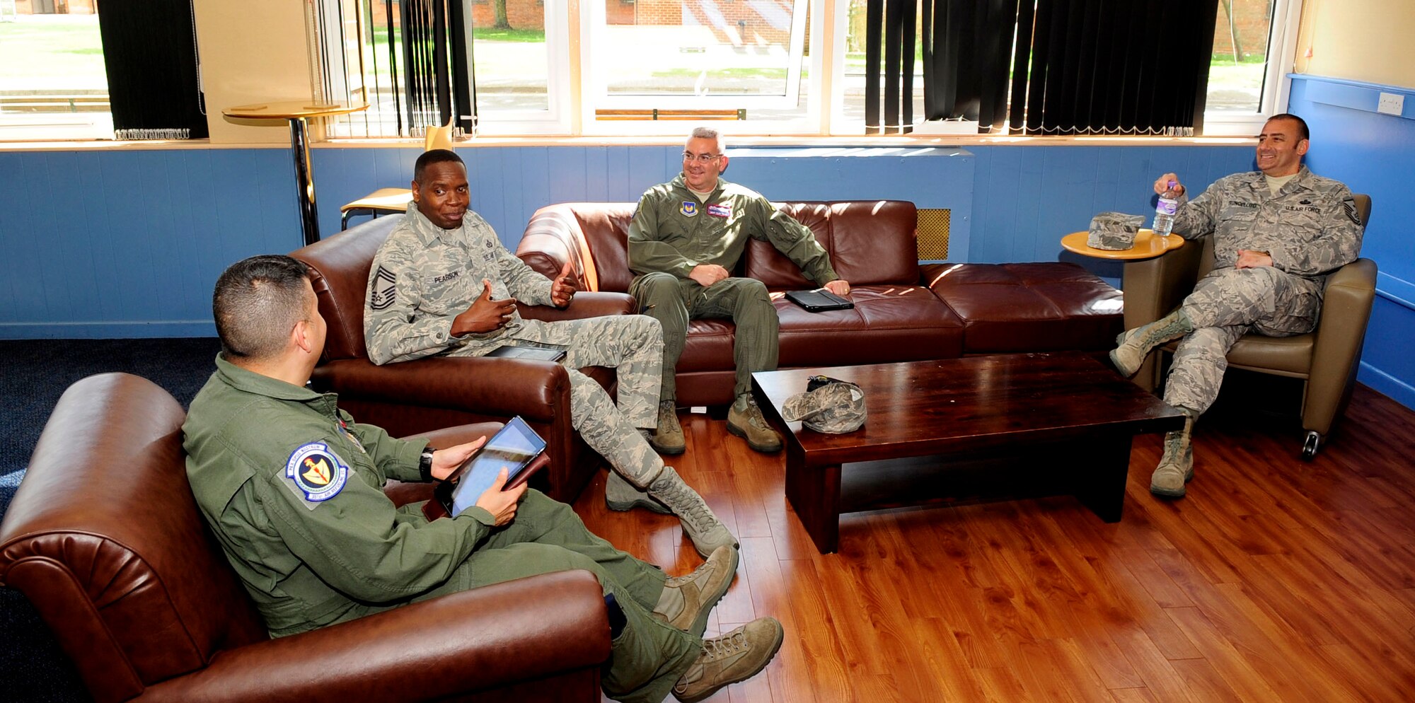 RAF MILDENHALL, England – Second from left, Chief Master Sgt. Anthony Pearson, Army and Air Force Exchange Services senior enlisted advisor, discusses ways to improve AAFES services with members of RAF Mildenhall’s Top 3 Aug. 28, 2012, during a site visit to RAF Mildenhall. Pearson visited to evaluate the exchange here and at several other bases. (U.S. Air Force/photo Senior Airman Ethan Morgan)