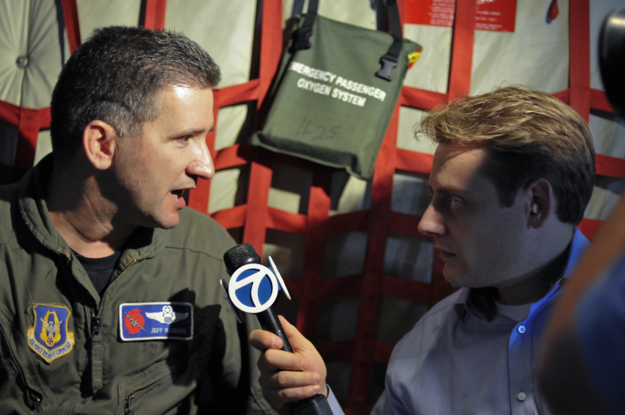 Maj. Jeff Ragusa, now a lieutenant colonel, is a pilot with the 53rd Weather Reconnaissance Squadron interviewed by on-air meteorologist, Todd Yakoubian onboard a WC-130J Hurricane Hunter aircraft during a mission into Hurricane Ike September 11, 2008. (U.S. Air Force Photo/Tech. Sgt. James B. Pritchett)
