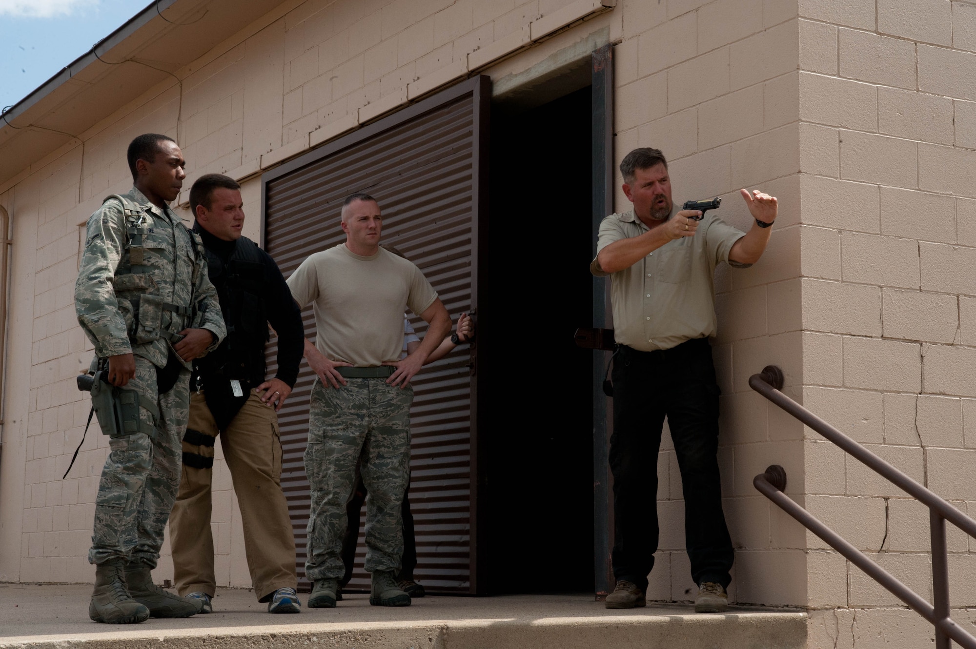 Dion Harris (far right), 28th Security Forces lead training instructor, helps 28th SFS Airmen prepare to run through an active shooter course at Ellsworth Air Force Base, S.D., Aug. 24, 2012. The course focused on preparing Defenders to rapidly and effectively respond to an active shooter scenario. (U.S. Air Force photo by Airman 1st Class Zachary Hada/Released)