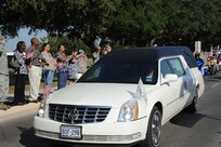 The remains of Sgt. Louis R. Torres were transported through Joint Base San Antonio-Randolph Aug. 29. JBSA-Randolph's Harmon Drive was lined with Randolph employees and family members paying final tribute to Torres as his remains were transported back to Ohio. Torres was assigned to the 2nd Battalion, 3rd Infantry Regiment, 3rd Stryker Brigade Combat Team, 2nd Infantry Division at Joint Base Lewis-McChord.  He deployed to Afghanistan with his brigade in December 2011 for his second deployment in support of Operation Enduring Freedom.  He died Aug. 22 from wounds suffered after he encountered an enemy IED Aug. 6 in Kandahar. (U.S. Air Force photo by Rich McFadden) 