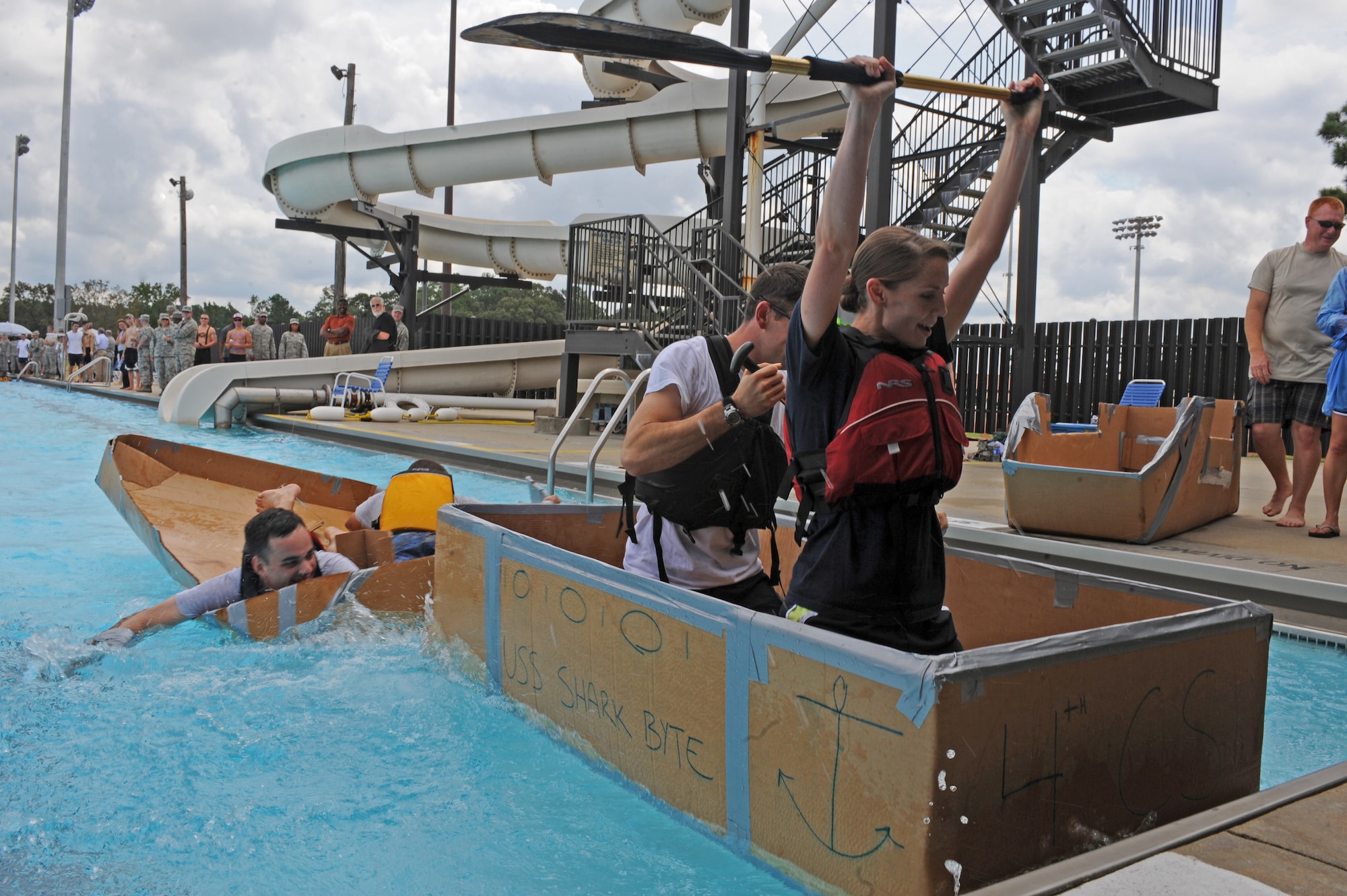 U.S. Air Force 1st Lt. Heather Flynn, 4th Communications Squadron operations flight commander, celebrates in victory during a build-a-boat competition on Seymour Johnson Air Force Base, N.C., Aug. 22, 2012. The 4th CS competitors won the race with a time of 42 seconds. (U.S. Air Force photo/Airman 1st Class John Nieves Camacho/Released)