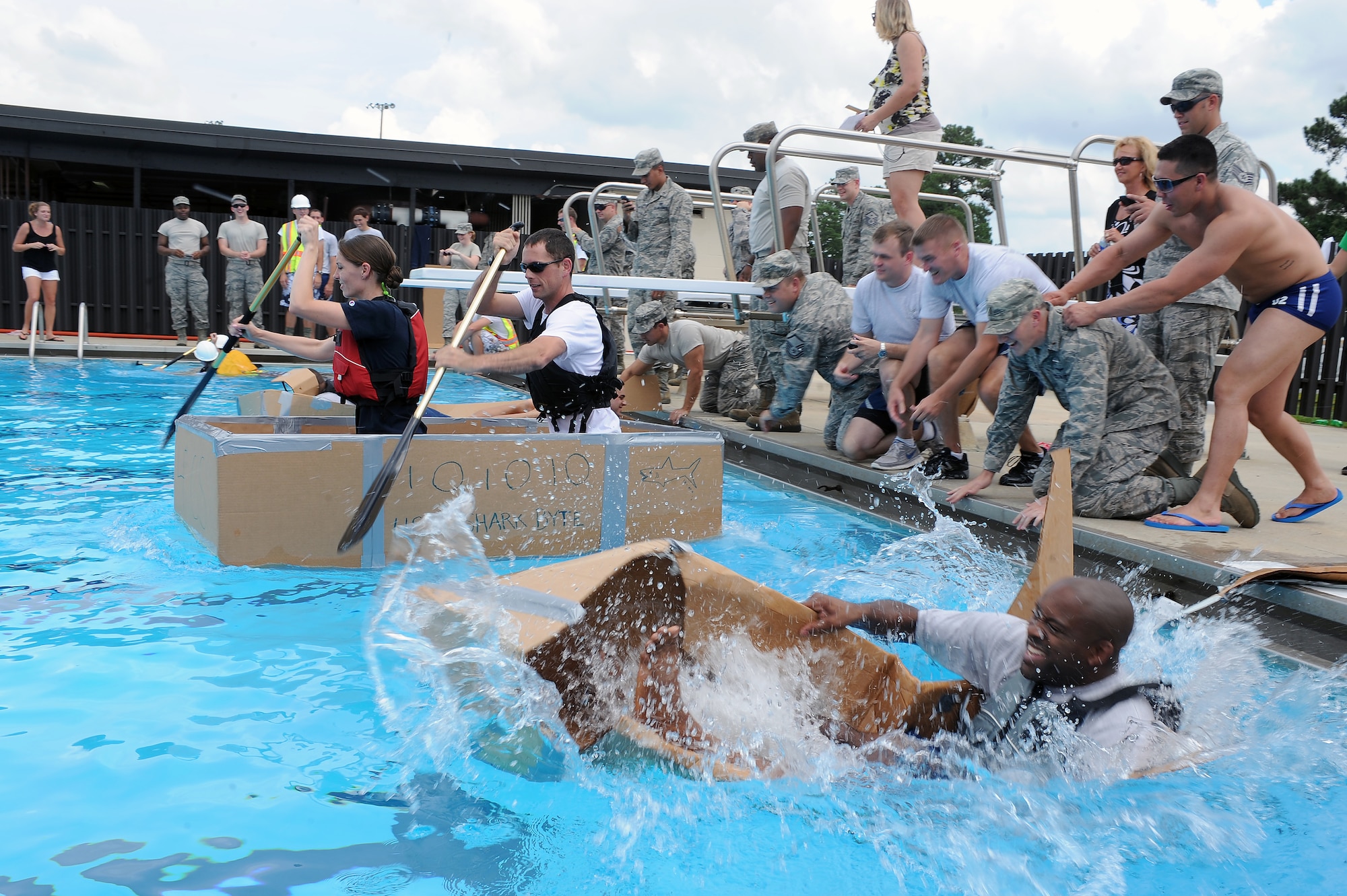 A contestant’s boat sinks at the start of a build-a-boat competition on Seymour Johnson Air Force Base, N.C., Aug. 22, 2012. The build-a-boat competition was a morale-boosting event held by the community center that developed team-building skills. (U.S. Air Force photo/Airman 1st Class John Nieves Camacho/Released)