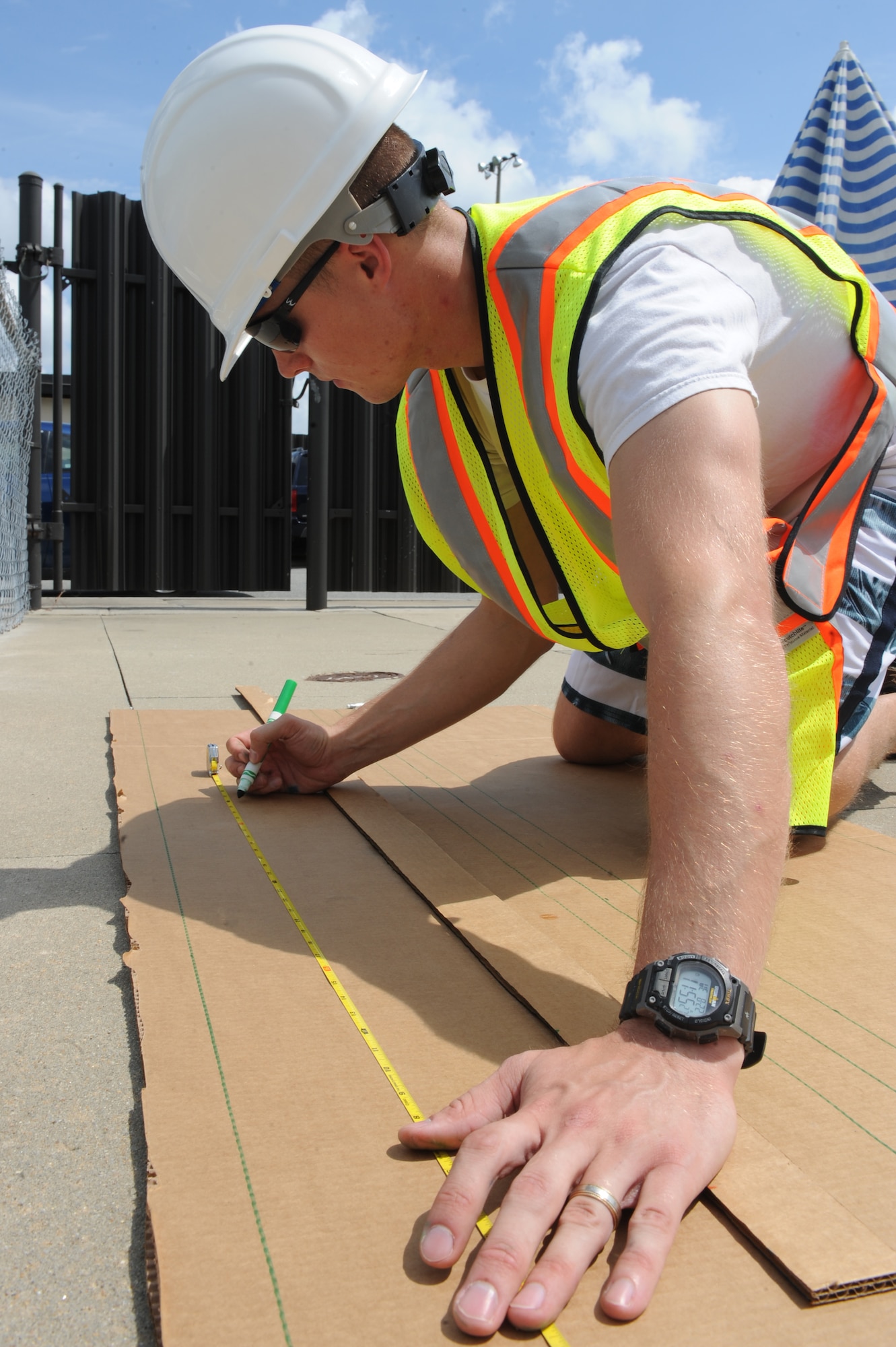 U.S. Air Force 1st Lt. Chris Dommert, 4th Civil Engineer Squadron asset manager, takes measurements on cardboard during a build-a-boat competition on Seymour Johnson Air Force Base, N.C., Aug. 22, 2012. Teams were given one hour to construct a boat out of cardboard and duct tape. (U.S. Air Force photo/Airman 1st Class John Nieves Camacho/Released)