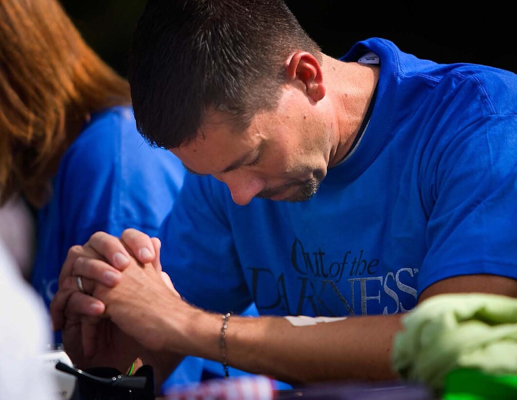 A participant in the Out of Darkness Community Walk in 2011 takes a moment to remember a lost family member. This year, the walk will be held at Mt. Trashmore, Va., Sept. 8, beginning at 8:30 a.m. (Courtesy photo)