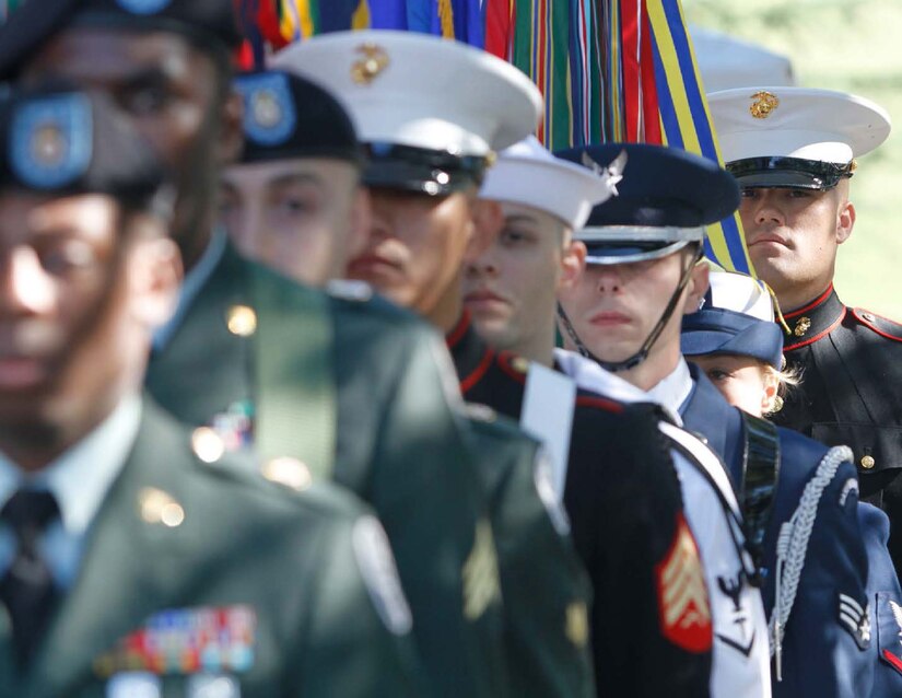 Service members from each branch of the military prepare to march