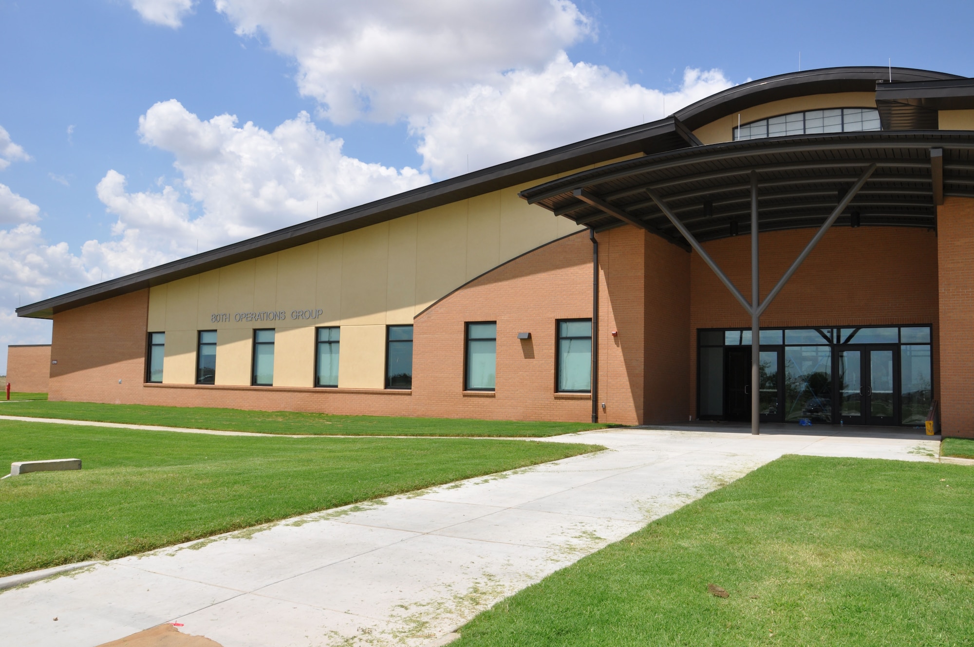 Front view of completed 80th Flying Training Wing Operations Group facility Aug. 28, 2012 at Sheppard Air Force Base, Texas.  The new building is estimated to save 50 percent annually in utility costs using energy-saving principles, which also increases sustainability.  (U.S. Air Force photo/2Lt Sara Harper)