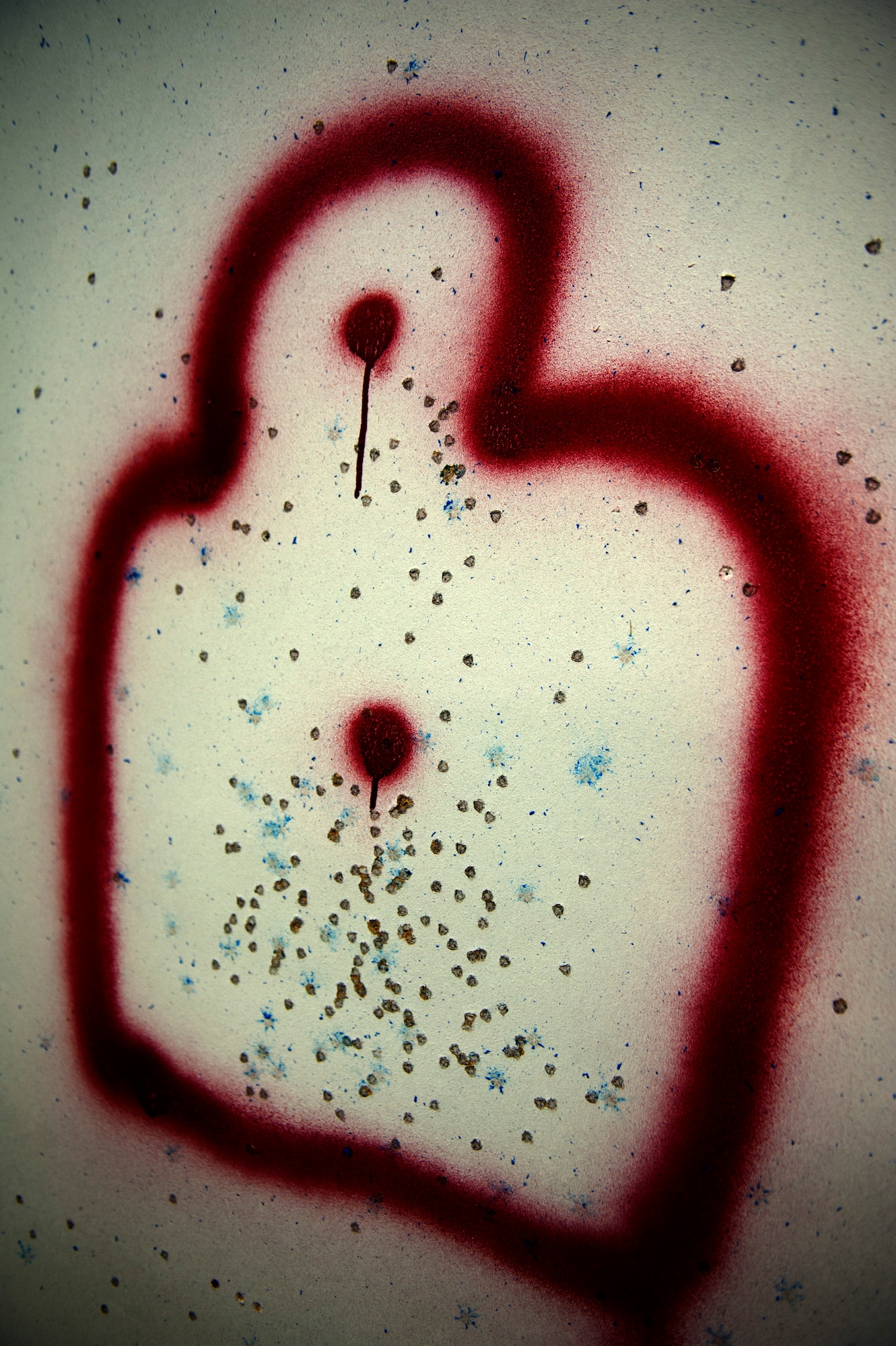 SPANGDAHLEM AIR BASE, Germany – A painted silhouette of a human figure is riddled with simulation bullet holes shot by 52nd Security Forces Squadron Airmen during an active-shooter exercise inside a training warehouse here Aug. 28.  In this active-shooter training, 52nd SFS Airmen must enter a house under control of hostile forces and eliminate the threat while identifying and controlling non-hostile inhabitants.  Security forces Airmen put their skills and knowledge to the test in simulated hostile environments to prepare for real-world events. (U.S. Air Force photo by Airman 1st Class Gustavo Castillo/Released)