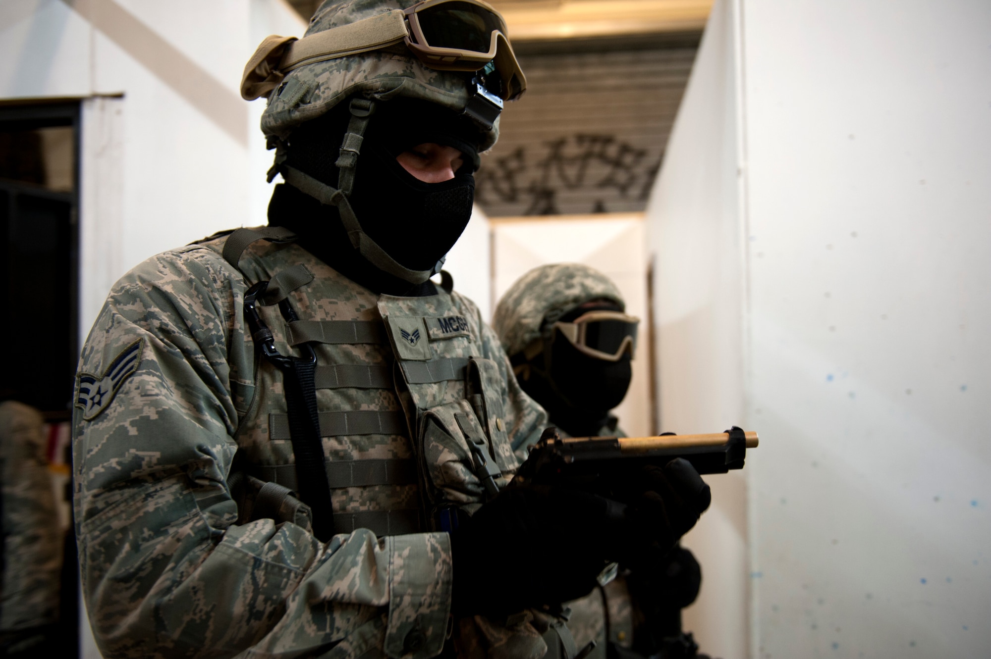 SPANGDAHLEM AIR BASE, Germany – Airman 1st Class Steven McGhee, 52nd Security Forces Squadron entry controller, clears his weapon of ammunition during an active-shooter exercise inside a training warehouse here Aug. 28.  In this active-shooter training, 52nd SFS Airmen must enter a house under control of hostile forces and eliminate the threat while identifying and controlling non-hostile inhabitants.  Security forces Airmen put their skills and knowledge to the test in simulated hostile environments to prepare for real-world events. (U.S. Air Force photo by Airman 1st Class Gustavo Castillo/Released)