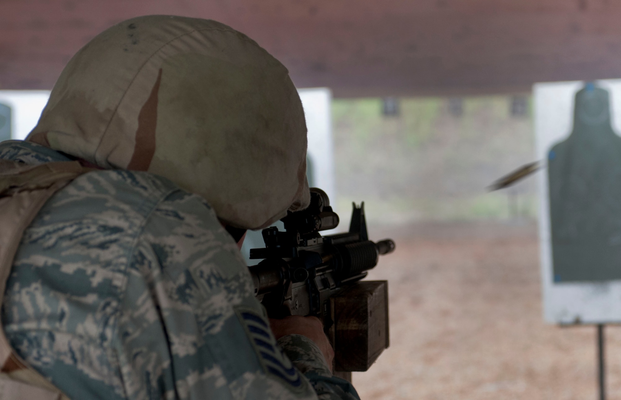 U.S. Air Force Tech Sgt. Greg Styer, 633rd Communications Squadron cyber transport technician, fires the M-4 Carbine during the Combat Arms course at Langley Air Force Base Va., Aug. 28, 2012.  Students fire at targets, during the live-fire drills, using various body positions such as prone, kneeling and standing. (U.S. Air Force photo by Senior Airman Stephanie Rubi / Released)