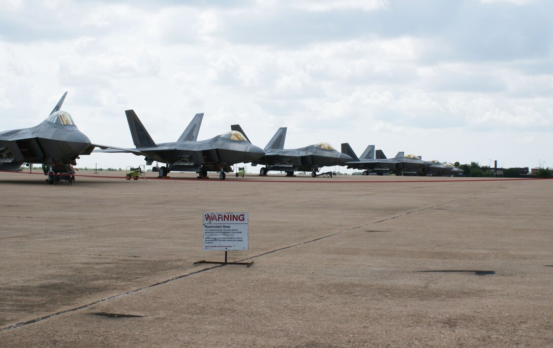 F-22 Raptors from Tyndall Air Force Base, Fla., sit on the ramp Aug. 28, 2012, at Sheppard Air Force Base, Texas.  The 82nd Training Wing and 80th Flying Training Wing assisted in bedding down 14 aircraft and 40 personnel after their evacuation due to Hurricane Issac.  (U.S. Air Force photo/Dan Hawkins)