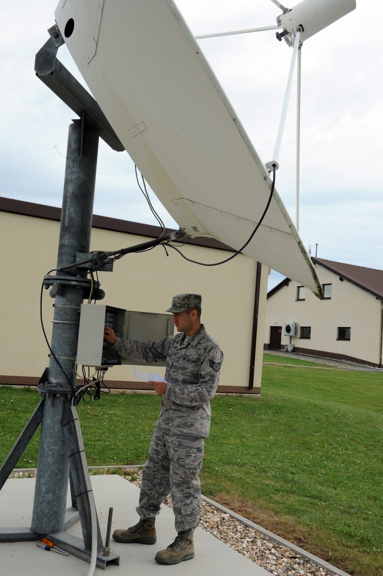SPANGDAHLEM AIR BASE, Germany – Staff Sgt. Modesto Alcala, American Forces Network Detachment 9 broadcast maintenance supervisor, conducts an operational check of a satellite heater system outside the broadcast maintenance shop here Aug. 28. The system is designed to melt snow off of the dish to maintain the satellite signal. The broadcast maintenance shop helps AFN entertain and provide command information to their audience by ensuring all necessary equipment is fully operational. (U.S. Air Force photo by Senior Airman Christopher Toon/Released)