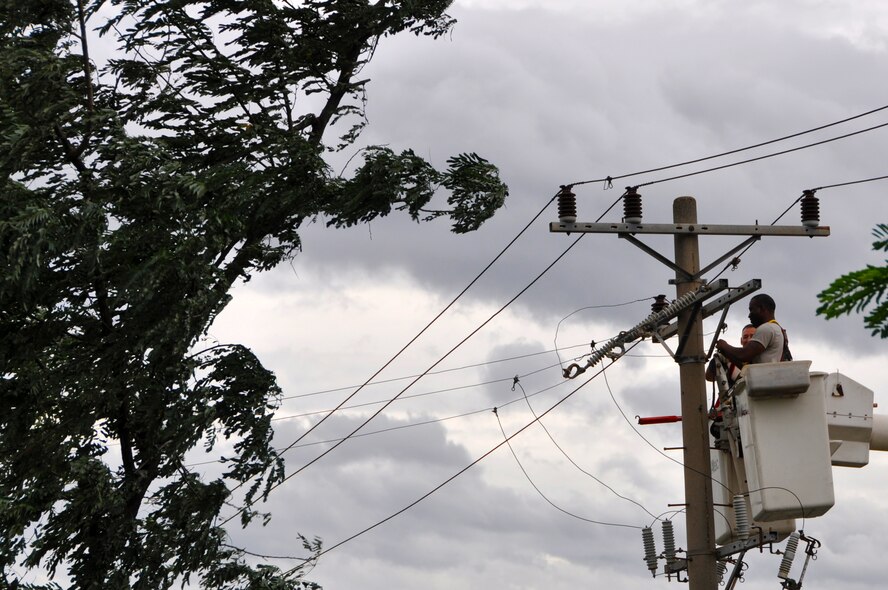 Master Sgt. Christopher Ernest and Tech. Sgt. Benjamin White work on power lines during the arrival of Typhoon Bolaven at Osan Air Base, Republic of Korea, Aug. 28, 2012. The base went into Tropical Cyclone Condition of Readiness (TCCOR) 1, with max gusts of winds at 50 knots throughout the day. The 51st Civil Engineer Squadron worked during the storm to keep Osan’s roads clear and to keep the power up and running. Ernest and White are both 51st CES electrical system craftsmen. (U.S. Air Force photo/Staff Sgt. Stefanie Torres)