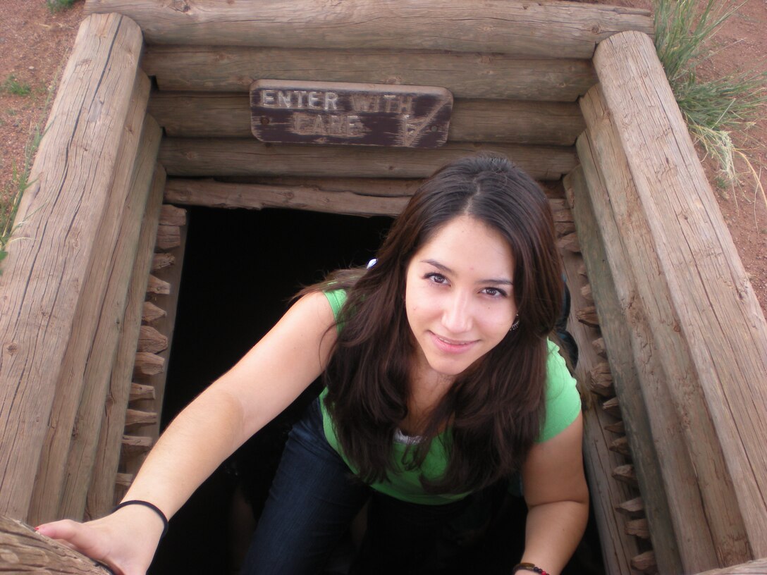 Katiana Torres ascends from a Kiva, an underground chamber used by Pueblos for religious rites, at the Pecos National Monument.  
