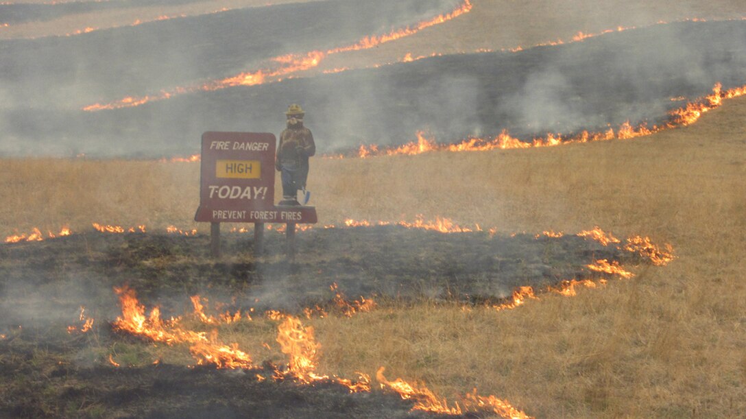 Smokey’s sign is surrounded by fire in a photo of the Whitewater-Baldy fire taken by Chris Ader from Three Points Fire District in Tucson, Ariz. 
