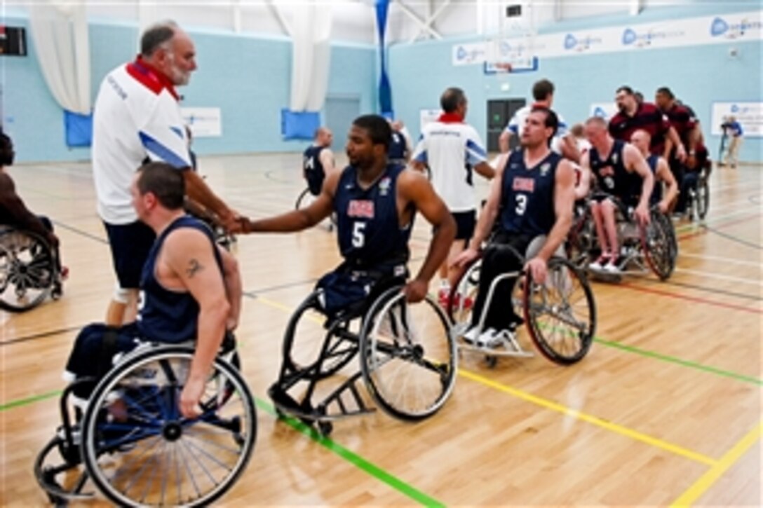 The 2012 U.S. and British Paralympic basketball teams show sportsmanship following their final opportunity to scrimmage at the University of East London before the start of Paralympic gameplay in London, Aug. 29, 2012. 